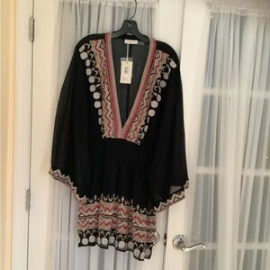 Embellished coverup for pool or play. Deep v-neck with fitted dropped waist.